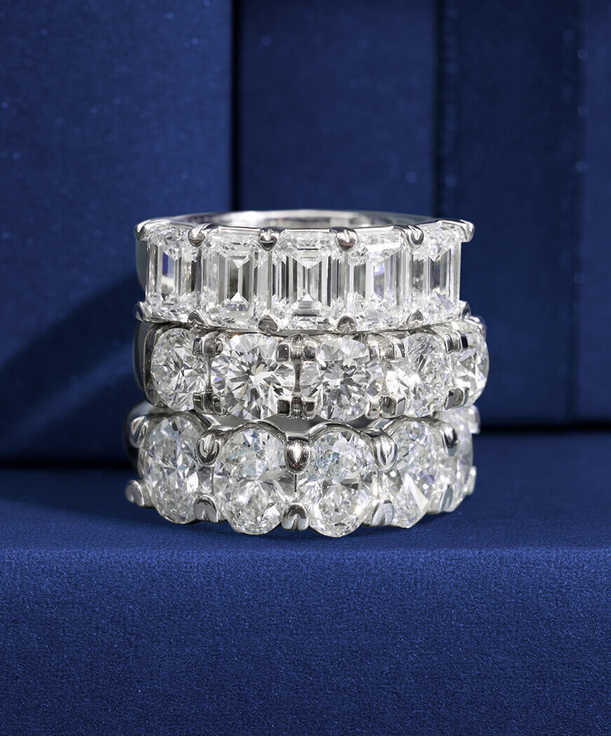 Three diamond rings stacked on a blue background