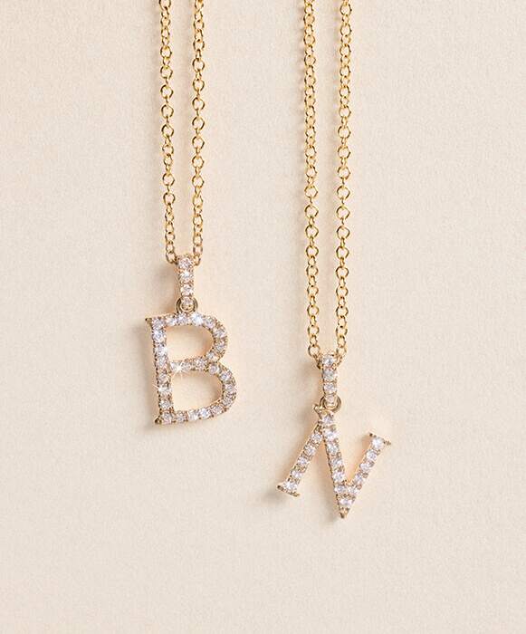 yellow gold diamond initial pendant necklace with letters B and N