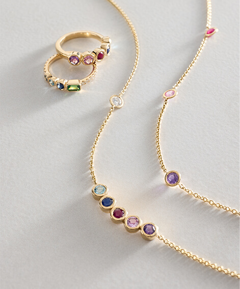 Personalized gemstone jewelry in yellow gold.