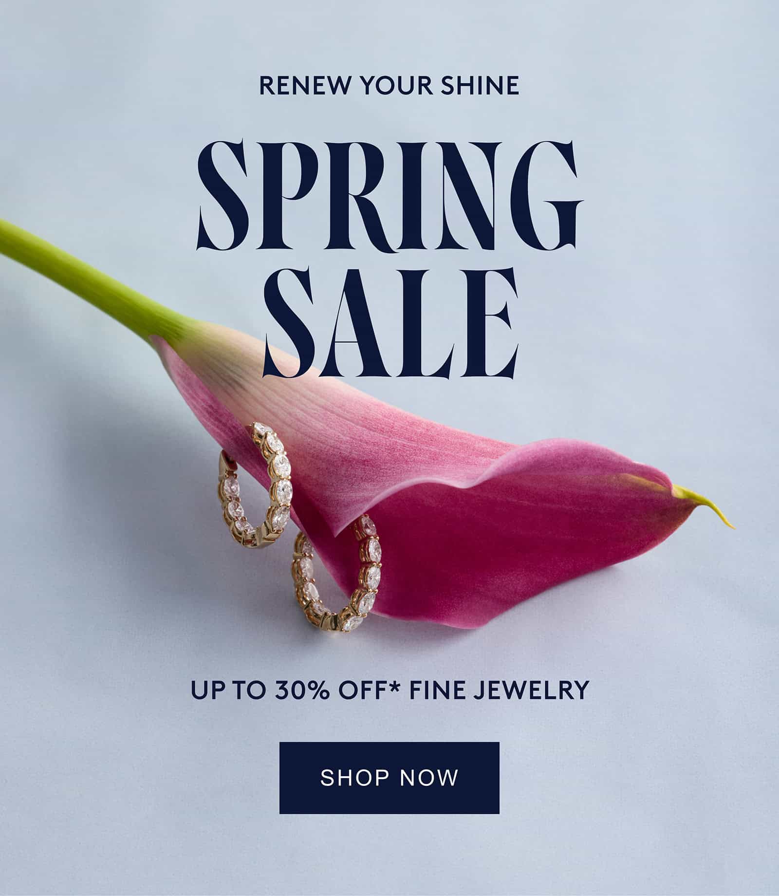 Gold diamond hoop earrings resting in a pink calla lily.