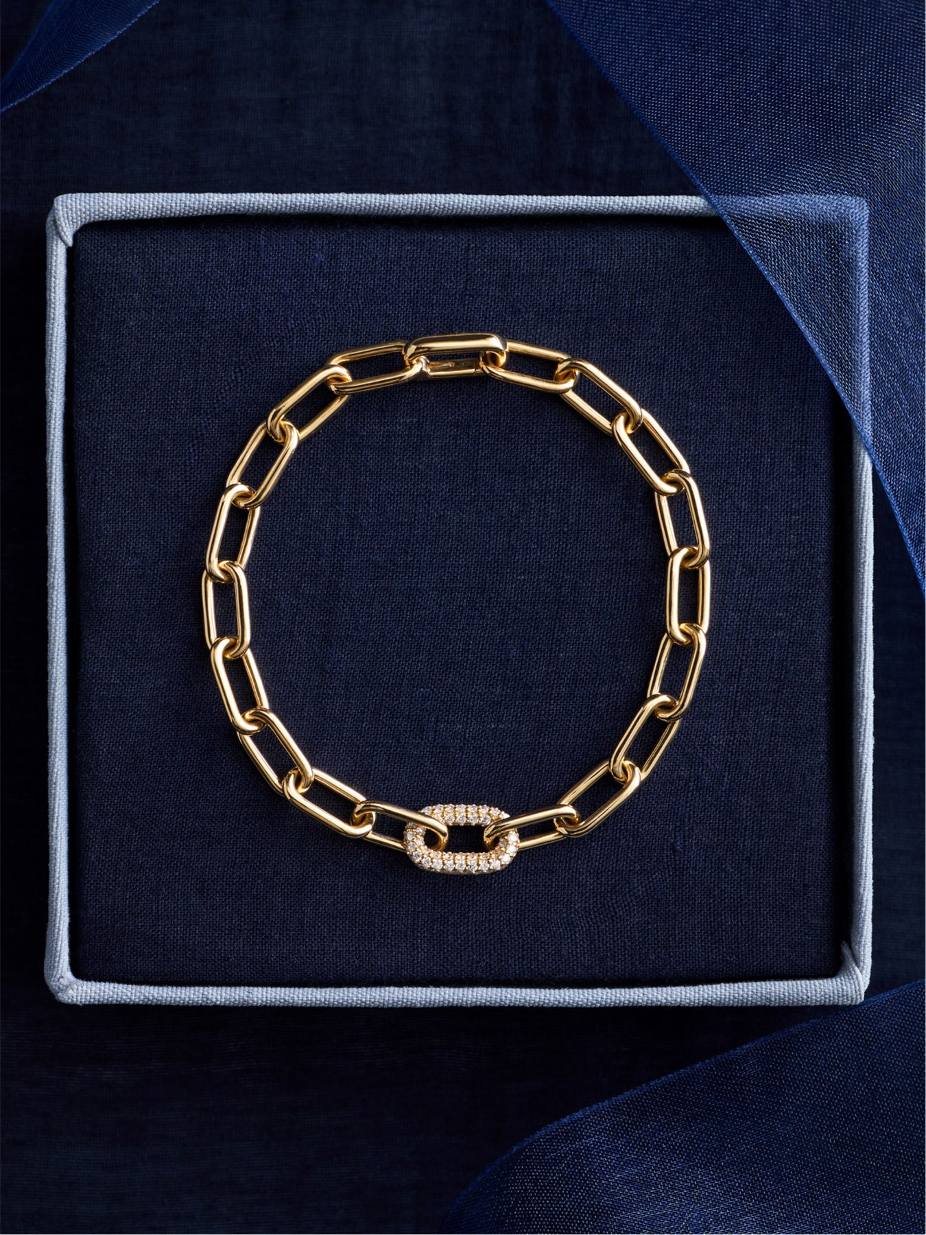 Ellipse collection gold link bracelet with pavé diamond oval accent displayed in gift box Blue Nile