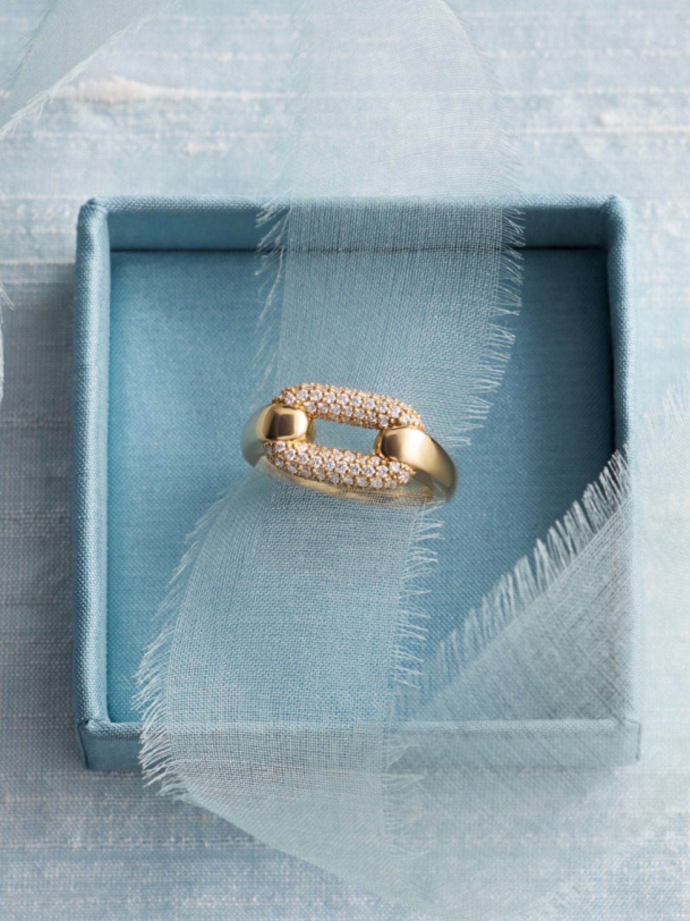 Ellipse collection gold oval link ring with pavé diamond design displayed in gift box Blue Nile