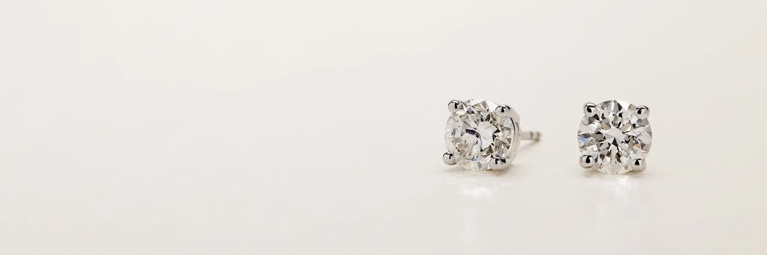 Diamond stud earrings in four-prong settings.